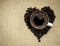 Coffee mug on beans shaped like a heart