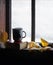 Coffee mug and book on windowsill