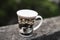 A coffee mug is resting on the wall of a rooftop terrace