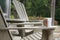 A coffee mug sitting on a Muskoka chair on a dock. Lake and cottages in the background - horizontal orientation. Perfect for