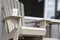 A coffee mug sitting on a Muskoka chair on a dock. Lake and cottages in the background - horizontal orientation. Perfect for