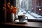 coffee mug on a snowy window ledge