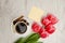 Coffee mug with spices, clean note, pink tulips on a wooden back