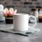 Coffee mug, a white cup on a table with flowers. Styled photo, product mockup