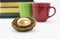 Coffee mugs, books, and gold nest egg