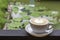 Coffee Mugs white plate with The heart shaped makeup on  iron balconies  Background Lotus pond