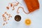 Coffee, orange and woolen hat on white background