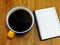 Coffee and papaer notebook on wooden background