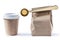 Coffee papercup and paperbag with big golden scoop isolated