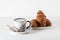 Coffee and pastries: a white coffee mug with a pattern, a silver spoon, fresh croissants on a saucer.