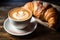 Coffee with a perfect latte art heart, next to a plate of fresh croissants. Generative AI