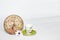 Coffee pot on a green saucer, decorative patterned clock and white daisy flower on a white background