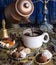 The coffee pot pours the coffee into the cup. in the oriental style. handmade candies, dried fruits and flowers. photo in the