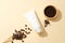 Coffee powder is contained in a wooden bowl, coffee beans and an unlabeled cosmetic tube on a pastel pink background. Coffee has