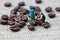 Coffee professional or expertise concept, miniature people figurine worker standing with roasted coffee beans on gunny