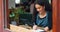 Coffee shop, checkout counter and a waitress writing in a notebook while working as a restaurant hostess. Cafe, smile