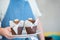 A coffee shop waiter holding a plate with two appetizing muffins