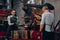 Coffee shop workers checking coffee beans roasting process together. Selective focus