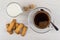 Coffee, spoon, brown sugar, milk, shortbread cookies with sesame