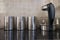 Coffee, sugar and tea containers resting next to a kettle of water