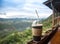 The coffee on table in the terrace over mountains landscape