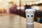 Coffee takeaway cup with cartoon eyes in cafe. Concept of hospitable cafe