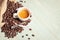 Coffee teaspoon and roasted beans on green background