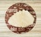 Coffee themed round tray and coffee filters on the wooden background
