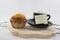 coffee on tray with muffin with white background, with one post-it