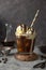 Coffee and vanilla ice crem with chocolate , coffee beans in glass cup, copy space. Lisestyle iced coffee drink