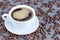 Coffee in white cup with coffee beans