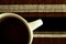 Coffee in White Cup on Striped Cloth Mat