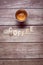 Coffee wooden letters on a wooden board with an espresso creamy coffee served on a cup