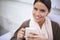 This coffee is worth savoring. Smiling young woman enjoying a mug of coffee.