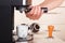 Coffeemaker hands inserts holder into coffee machine to make coffee