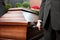 Coffin bearer carrying casket at funeral