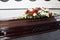 A coffin decorated with flowers. Beautiful farewell ceremony