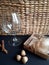 cognac glass, gift box, acorns, cinnamon sticks, bird feather on a black background.