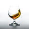 Cognac glass with splashing brandy inside