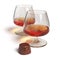 Cognac glasses and chocolate candy