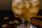 Cognac and ice in a glass with cinnamon and almonds