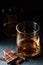 Cognac or rum or Bourbon in a glass. Pieces of chocolate. Alcohol tasting. Dark background