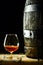 Cognac snifter and an old oak barrel