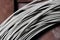 A coil of fechral thick refractory wire hangs in a warehouse of goods for ceramists. Frame of coiled nichrome wire for