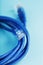 A coil of an Internet network cable for data transmission on a blue background