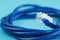 A coil of an Internet network cable for data transmission on a blue background