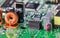 Coil or varied electronic components on green printed circuit board detail