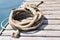 Coiled marine rope on wooden pier