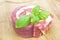 Coiled raw beef with basil