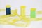 Coils with multi-colored yellow, green, blue threads and decorative yellow ribbon